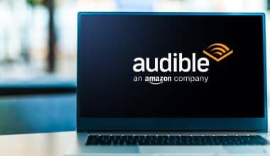 Laptop displaying logo of Audible, an American online audiobook and podcast service owned by Amazon.com Inc